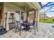 An outdoor dining area with a ceiling fan offers al fresco entertaining at 7024 Bradbury Cir, Wesley Chapel, FL 33545