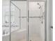 Glass enclosed shower adjacent to tub with double shower head at 7024 Bradbury Cir, Wesley Chapel, FL 33545
