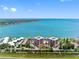 Panoramic aerial view of waterfront condos with stunning bay views, lush greenery and community tennis court at 7430 Sunshine Skyway S Ln # 602, St Petersburg, FL 33711