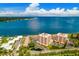 Aerial image offering scenic views of waterfront condos, serene water, community pools, and lush greenery at 7430 Sunshine Skyway S Ln # 602, St Petersburg, FL 33711