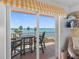 Balcony with table and chairs through open sliding glass doors, with lovely water views at 7430 Sunshine Skyway S Ln # 602, St Petersburg, FL 33711
