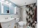 This bathroom features a blue accent wall and a shower and tub with a decorative curtain at 7430 Sunshine Skyway S Ln # 602, St Petersburg, FL 33711