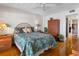 This bedroom features a ceiling fan, a wardrobe and an ensuite bathroom at 7430 Sunshine Skyway S Ln # 602, St Petersburg, FL 33711