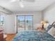 Cozy bedroom with water views and access to a balcony through a sliding door at 7430 Sunshine Skyway S Ln # 602, St Petersburg, FL 33711