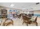 Inviting clubhouse area with comfortable wicker seating, bookshelves, and sliding doors to an outdoor patio at 7430 Sunshine Skyway S Ln # 602, St Petersburg, FL 33711
