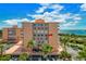 Condos with balconies offering waterfront views, white railings, lush palm trees, and well-maintained parking at 7430 Sunshine Skyway S Ln # 602, St Petersburg, FL 33711