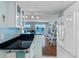 Open kitchen view showcasing granite counters, sleek appliances, and seamless flow to the living room with water views at 7430 Sunshine Skyway S Ln # 602, St Petersburg, FL 33711