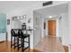 Modern kitchen with black countertop island and bar stool seating, opening to a tiled foyer at 7430 Sunshine Skyway S Ln # 602, St Petersburg, FL 33711