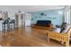 Cozy living room showcases hardwood floors, comfortable furnishings, and an open flow to kitchen and dining area at 7430 Sunshine Skyway S Ln # 602, St Petersburg, FL 33711