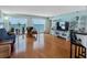Bright living room featuring balcony access with water views, hardwood floors, and contemporary furnishings at 7430 Sunshine Skyway S Ln # 602, St Petersburg, FL 33711