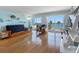 Sunlit living room with wood floors, comfortable seating, and balcony showcasing stunning views of the water at 7430 Sunshine Skyway S Ln # 602, St Petersburg, FL 33711