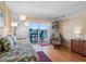 Bright living room offers a daybed and a sliding glass door to a balcony with a water view at 7430 Sunshine Skyway S Ln # 602, St Petersburg, FL 33711