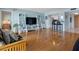 Open-concept living area with wood floors, stylish decor, and a kitchen view featuring bar seating at 7430 Sunshine Skyway S Ln # 602, St Petersburg, FL 33711