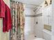Updated shower area with tiled walls, rainfall shower head, and glass door at 7430 Sunshine Skyway S Ln # 602, St Petersburg, FL 33711