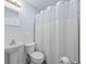 Cozy bathroom with white wainscoting, pedestal sink, and black and white tile floor at 744 53Rd N Ter, St Petersburg, FL 33703