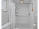 Modern bathroom with a white tiled shower and black and white patterned tile flooring at 744 53Rd N Ter, St Petersburg, FL 33703