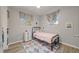 Cozy bedroom features a twin bed, colorful rug, and windows with patterned curtains at 744 53Rd N Ter, St Petersburg, FL 33703