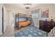 Comfortable bedroom with bunk beds, dresser, and blue rug, perfect for children at 744 53Rd N Ter, St Petersburg, FL 33703