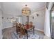 Inviting dining area with modern lighting, classic wood furniture, and stylish area rug at 744 53Rd N Ter, St Petersburg, FL 33703