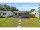 Charming single-story home featuring a well-manicured lawn and inviting front porch with decorative stepping stones at 744 53Rd N Ter, St Petersburg, FL 33703