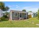 Well-maintained single-story home with a manicured lawn and inviting front entrance framed by lovely landscaping at 744 53Rd N Ter, St Petersburg, FL 33703