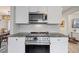 Modern kitchen with stainless steel appliances, granite countertop, and mosaic backsplash at 744 53Rd N Ter, St Petersburg, FL 33703
