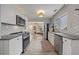Stylish kitchen with stainless steel appliances, modern cabinetry, and a charming breakfast nook area at 744 53Rd N Ter, St Petersburg, FL 33703
