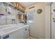 Laundry area with washer, dryer, shelving, and window providing natural light at 744 53Rd N Ter, St Petersburg, FL 33703