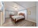 Bright bedroom features a wooden bed frame, ceiling fan, and luxury vinyl plank flooring at 744 53Rd N Ter, St Petersburg, FL 33703