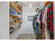 Organized walk-in closet with shelving, hanging rods, and luxury vinyl plank flooring at 744 53Rd N Ter, St Petersburg, FL 33703