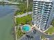 Aerial view of condo building showcasing the pool, waterfront location and city views at 80 Rogers St # 2D, Clearwater, FL 33756