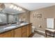 Bathroom with double sinks, granite counters, and storage at 80 Rogers St # 2D, Clearwater, FL 33756