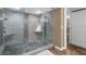 Bathroom featuring a stylish walk-in shower with pebble floor and modern fixtures at 80 Rogers St # 2D, Clearwater, FL 33756