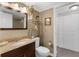 Bathroom with granite countertop, decorative shelving, and closet access provides ample space at 80 Rogers St # 2D, Clearwater, FL 33756