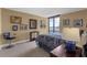 Bedroom with views, art, and a work chair offers a relaxed vibe at 80 Rogers St # 2D, Clearwater, FL 33756