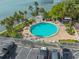 Relax and unwind at the community pool with ample lounge chairs and lush tropical landscaping at 80 Rogers St # 2D, Clearwater, FL 33756