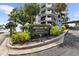 Prelude 80 building entrance sign, featuring visitor parking directions and nicely maintained landscaping at 80 Rogers St # 2D, Clearwater, FL 33756