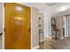 Condo hallway featuring a stylish door, modern wall decor, and wood-look flooring for a welcoming entry at 80 Rogers St # 2D, Clearwater, FL 33756