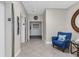 Well-maintained hallway near elevators, with seating and a stylish round mirror on the wall at 80 Rogers St # 2D, Clearwater, FL 33756