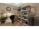 Bright home office with sleek desk, storage shelves, and wood-look flooring at 80 Rogers St # 2D, Clearwater, FL 33756