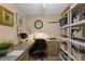 Bright home office with sleek desk, storage shelves, and wood-look flooring at 80 Rogers St # 2D, Clearwater, FL 33756