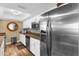 Bright kitchen features stainless steel appliances, granite counters, and white cabinetry at 80 Rogers St # 2D, Clearwater, FL 33756