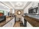 Charming kitchen with granite countertops and backsplash, plus a stainless steel microwave at 80 Rogers St # 2D, Clearwater, FL 33756