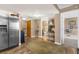Inviting lower-level Gathering room with a full-sized refrigerator and an open entrance to the restroom at 80 Rogers St # 2D, Clearwater, FL 33756