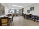 This is a lounge with tile floors, tables and chairs, views through large glass walls and comfortable sofa seating at 80 Rogers St # 2D, Clearwater, FL 33756