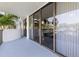 Large patio with sliding glass doors and a view of the water at 80 Rogers St # 2D, Clearwater, FL 33756