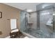Modern walk-in shower with pebble floor and glass enclosure at 80 Rogers St # 2D, Clearwater, FL 33756
