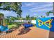 Enjoy outdoor living on this back yard deck with blue and yellow painted accent wall and a hot tub at 8074 37Th N Ave, St Petersburg, FL 33710
