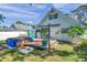 View of the house from the backyard with a deck, butterfly art, and a partially covered hot tub at 8074 37Th N Ave, St Petersburg, FL 33710
