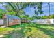 Spacious backyard with sheds and a lush green lawn and privacy fence at 8074 37Th N Ave, St Petersburg, FL 33710